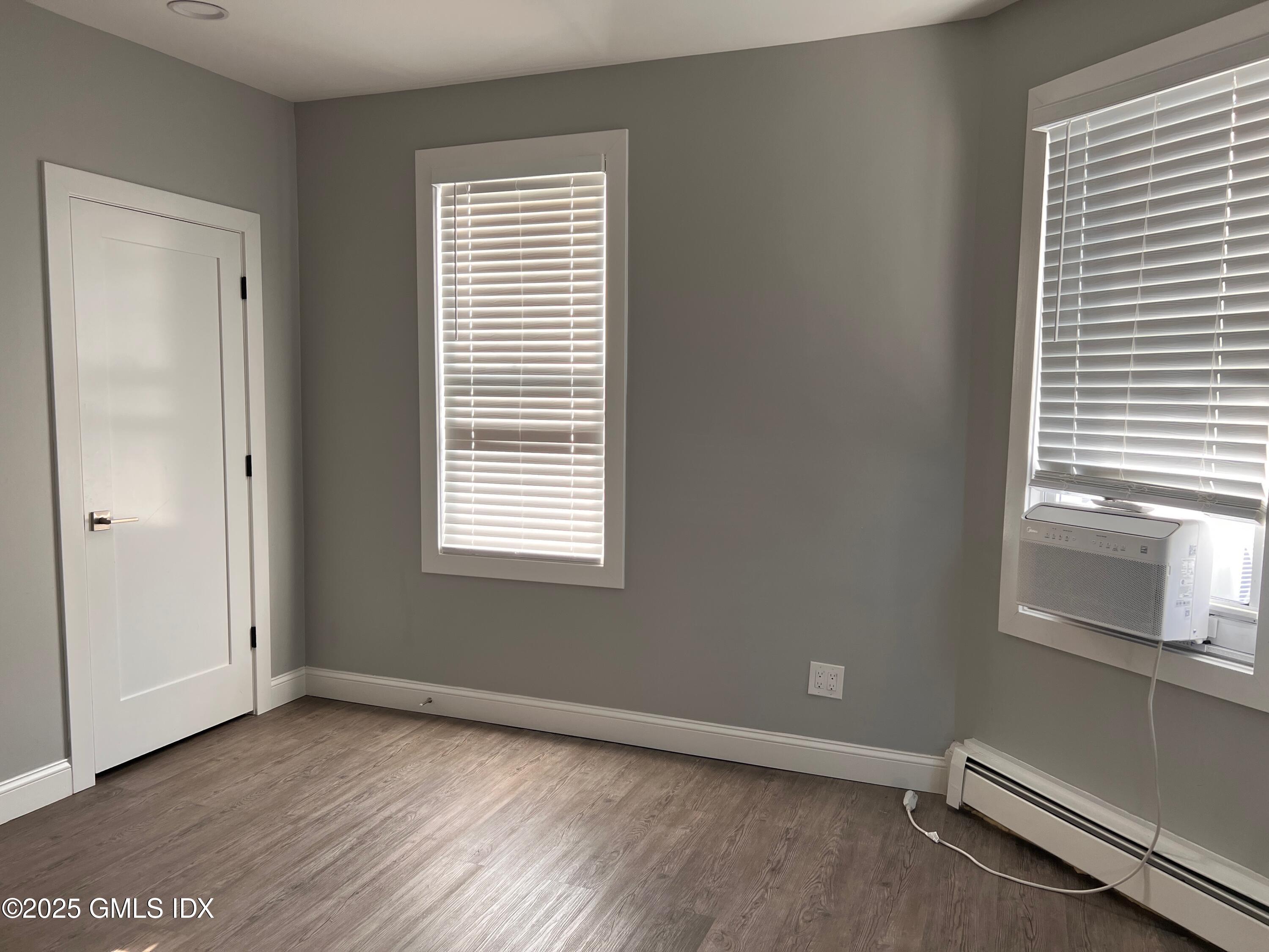 15 Beech Street, Unit 2N Greenwich, CT 06830 - Photo 5 of 15 an empty room with wooden floor and windows
