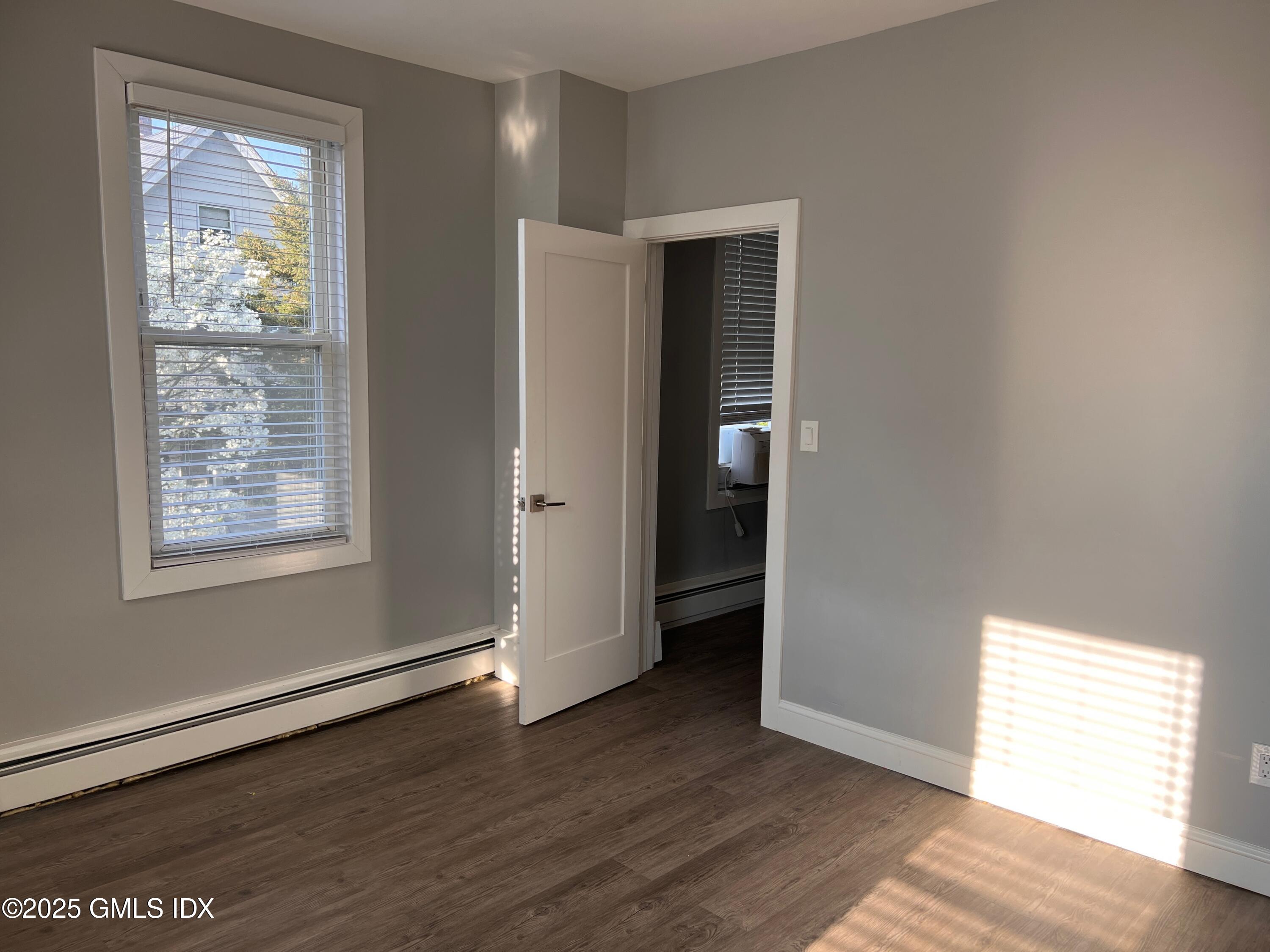 15 Beech Street, Unit 2N Greenwich, CT 06830 - Photo 8 of 15 an empty room with wooden floor closet and windows