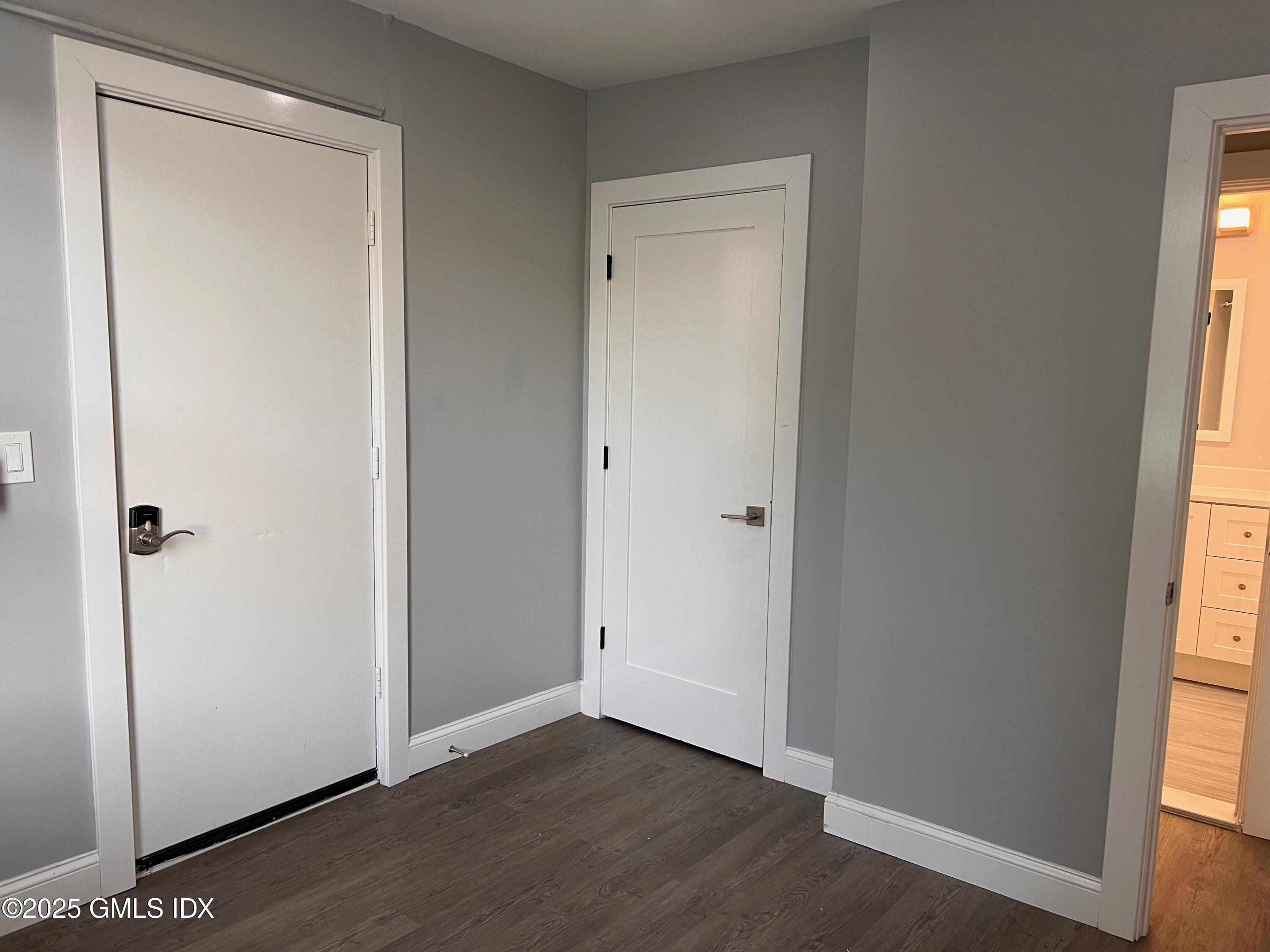 15 Beech Street, Unit 2N Greenwich, CT 06830 - Photo 10 of 15 a view of an empty room with wooden floor and a window