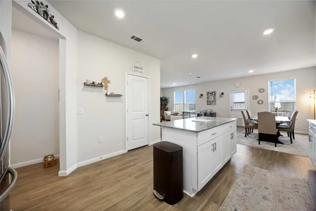 a kitchen with sink cabinets and wooden floor