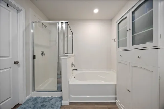 a bathroom with a bathtub and a shower