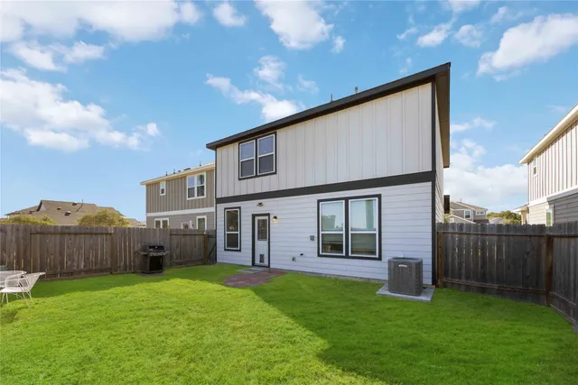 a view of a house with backyard and porch
