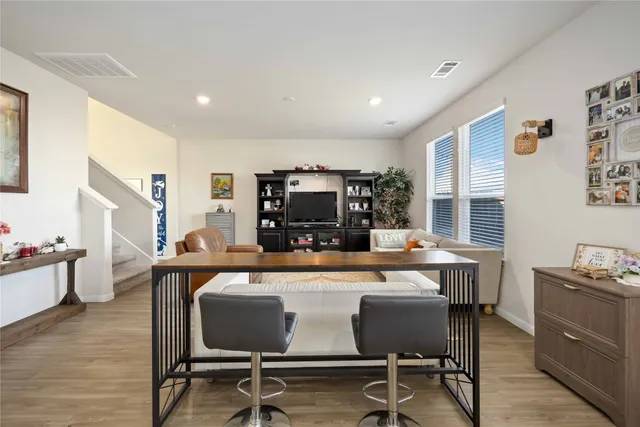 a view of a dining room with furniture and wooden floor