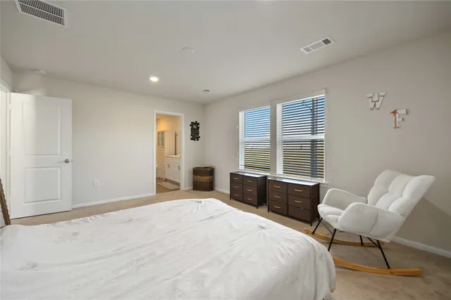 a bedroom with a bed and chair