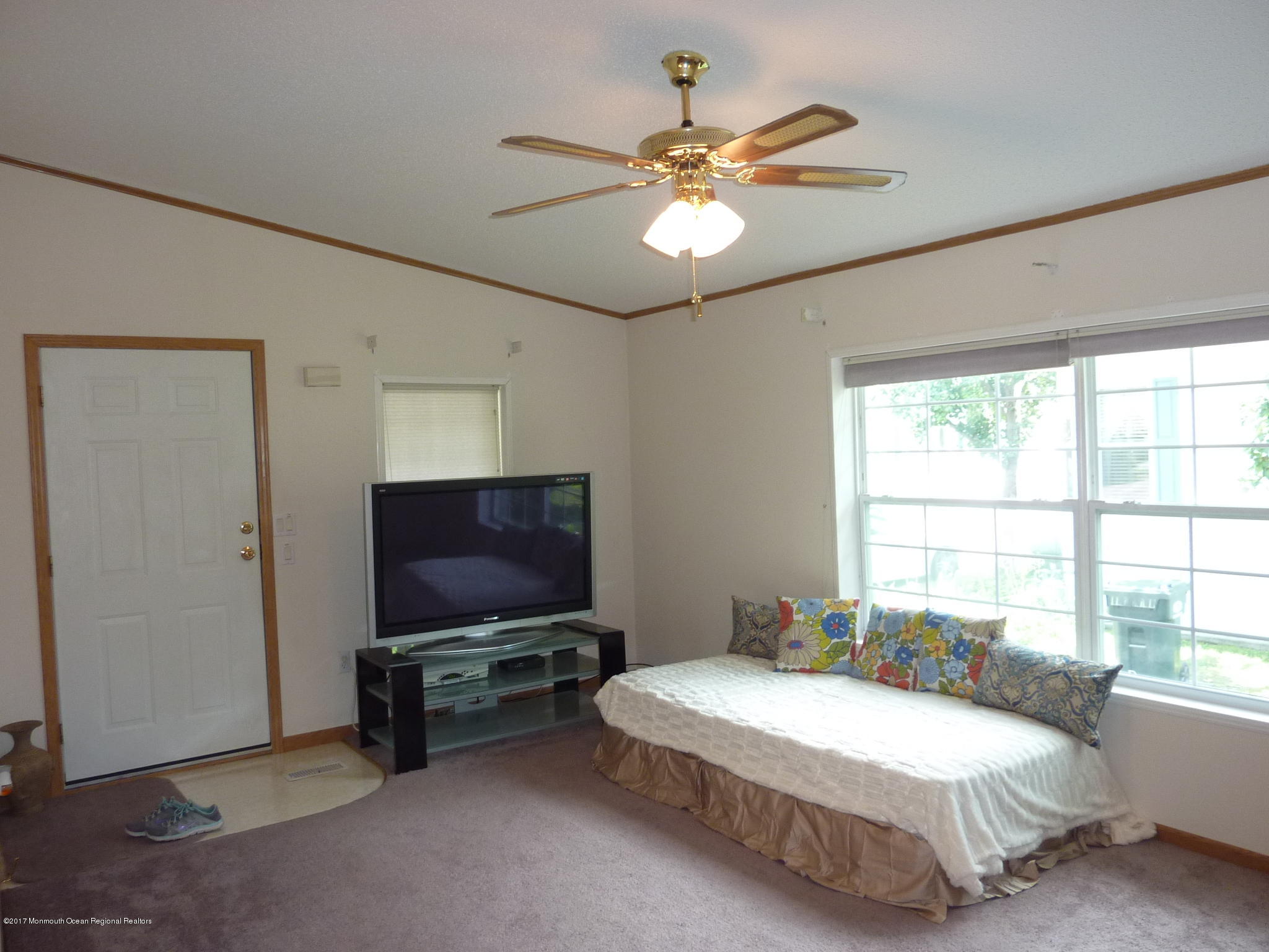 58 Village Road Morganville, NJ 07751 - Photo 4 of 8 a bedroom with a bed and a flat screen tv