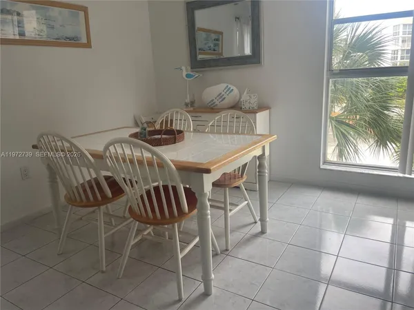a view of a dining room with furniture and window