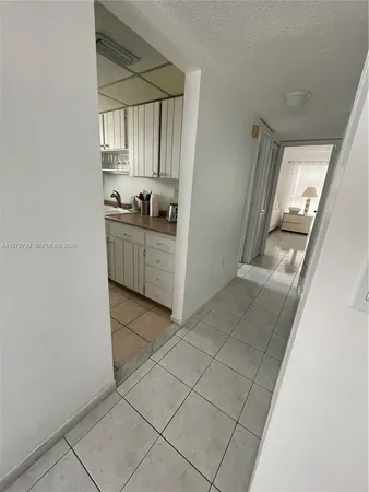 a kitchen with a sink a refrigerator and window
