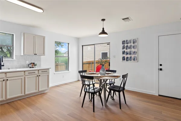 a view of a dining room with furniture window and wooden floor