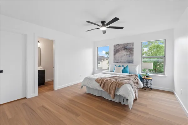 a bedroom with a bed and a large window