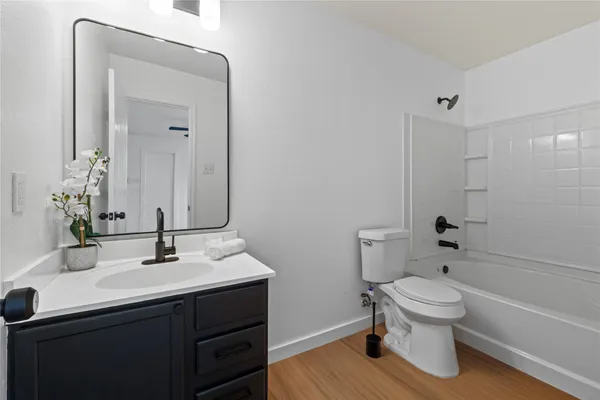 a bathroom with a sink toilet a shower and a mirror
