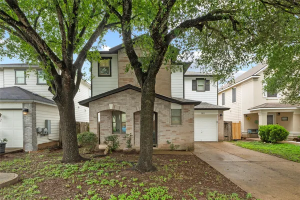 front view of a house with a trees