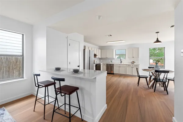 a view of a dining room with furniture and wooden floor