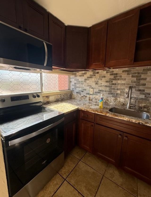 3676 Lower Honoapiilani Road, Unit C301 Lahaina, HI 96761 - Photo 7 of 49 a kitchen with granite countertop cabinets a sink and a stove