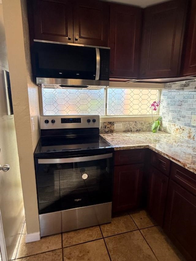 3676 Lower Honoapiilani Road, Unit C301 Lahaina, HI 96761 - Photo 9 of 49 a kitchen with a stove and a microwave