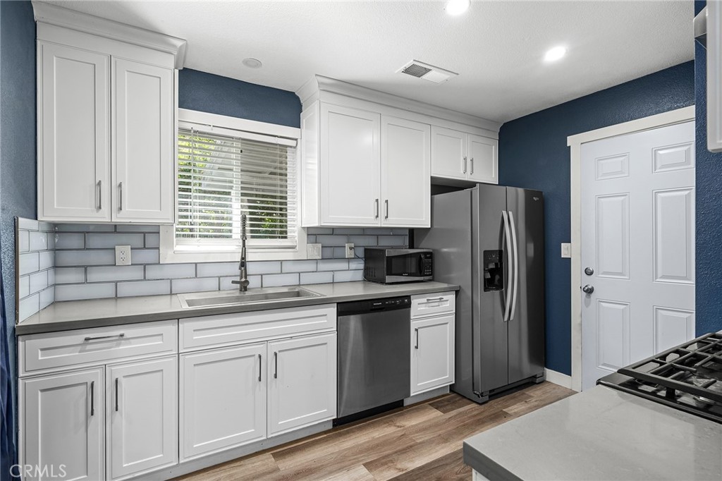 1131 Stewart Avenue Chico, CA 95926 - Photo 12 of 51 a kitchen with stainless steel appliances granite countertop a refrigerator sink and cabinets