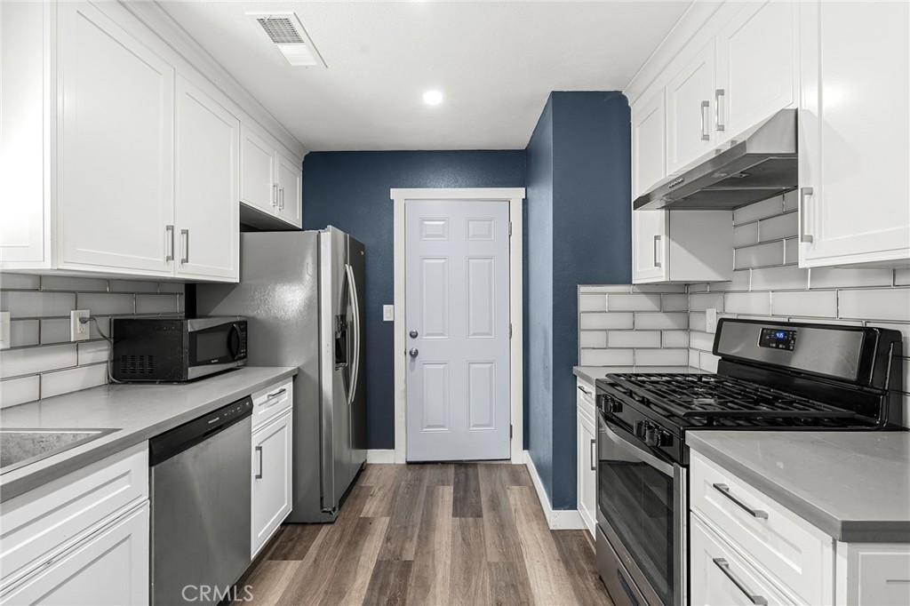 1131 Stewart Avenue Chico, CA 95926 - Photo 13 of 51 a kitchen with stainless steel appliances a refrigerator a sink a stove and cabinets