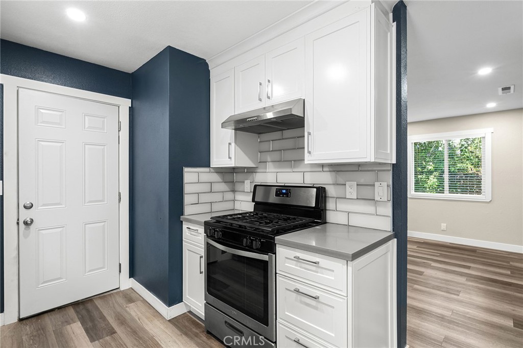 1131 Stewart Avenue Chico, CA 95926 - Photo 14 of 51 a kitchen with cabinets appliances and a wooden floor