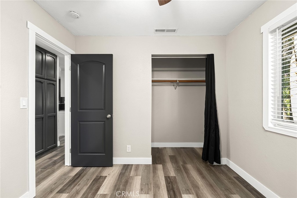 1131 Stewart Avenue Chico, CA 95926 - Photo 19 of 51 a view of a hallway with wooden floor and a bathroom