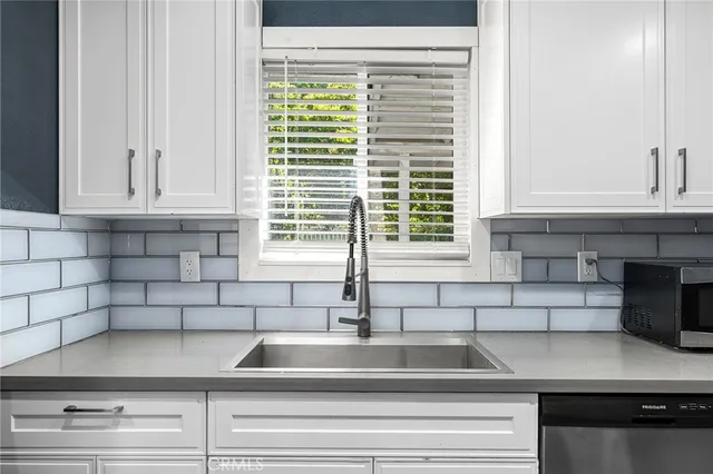 an aerial view of a houses with a yard and lake view