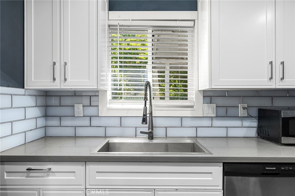 1131 Stewart Avenue Chico, CA 95926 - Photo 3 of 51 a kitchen with a sink and white cabinets