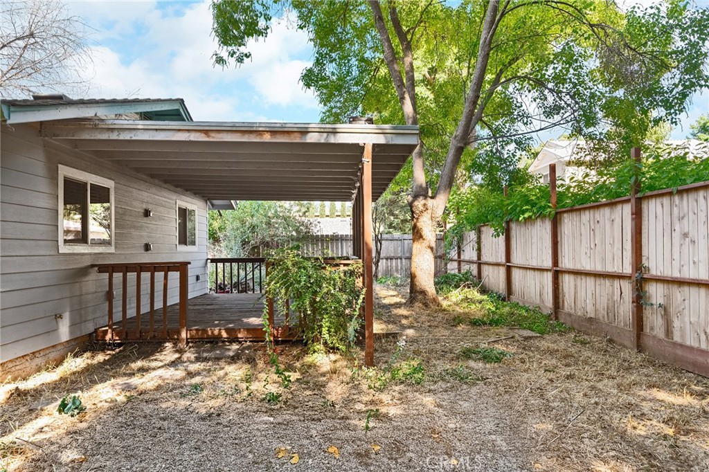 1131 Stewart Avenue Chico, CA 95926 - Photo 37 of 51 a view of a deck with a large tree and wooden fence
