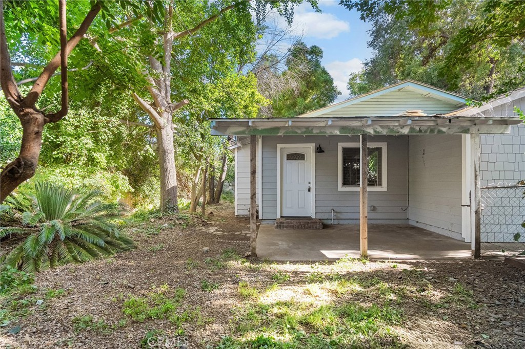 1131 Stewart Avenue Chico, CA 95926 - Photo 5 of 51 a backyard of a house with table and chairs under an umbrella