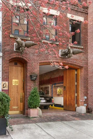 a view of a building with a door and a car parked in front of it