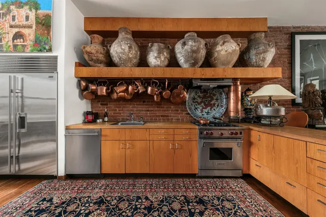 a kitchen with a stove a refrigerator and cabinets