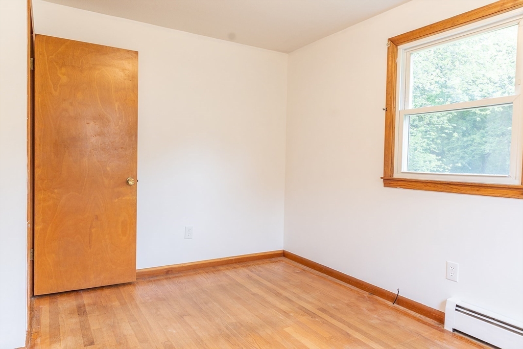 59 Mountain Road Holyoke, MA 01040 - Photo 13 of 40 a view of an empty room with wooden floor and a window