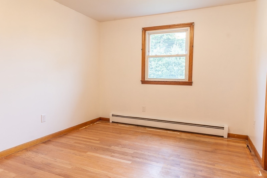 59 Mountain Road Holyoke, MA 01040 - Photo 16 of 40 an empty room with wooden floor and windows