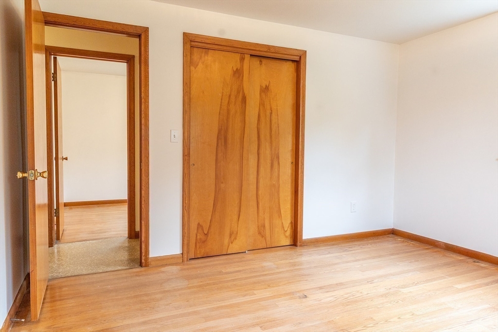 59 Mountain Road Holyoke, MA 01040 - Photo 20 of 40 an empty room with wooden floor and closet area