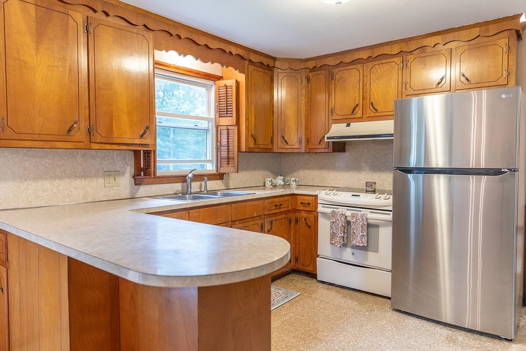 59 Mountain Road Holyoke, MA 01040 - Photo 2 of 40 a kitchen with stainless steel appliances a refrigerator a sink and cabinets