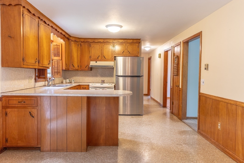 59 Mountain Road Holyoke, MA 01040 - Photo 6 of 40 a kitchen with stainless steel appliances granite countertop a refrigerator a sink and a cabinets