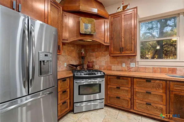 a kitchen with a stove microwave and refrigerator