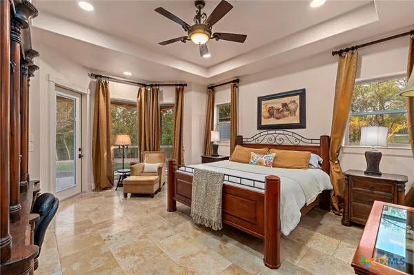 a spacious bedroom with a bed and a large window