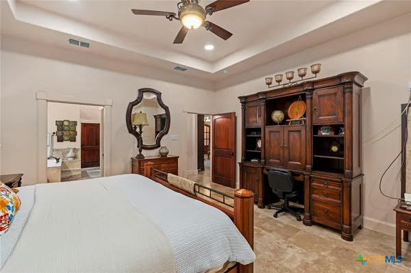 a bedroom with bed and a chandelier