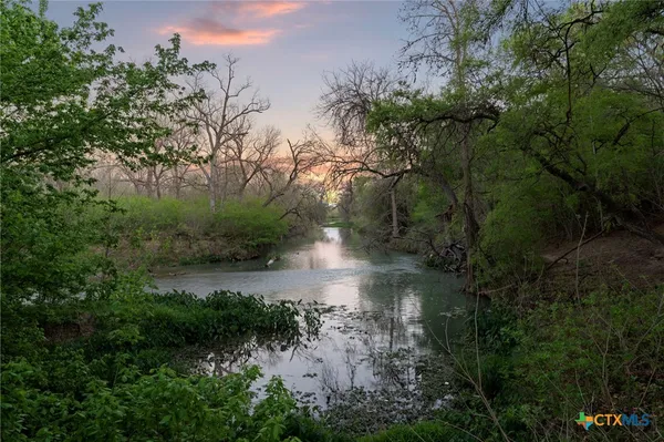 a view of water pond with green space