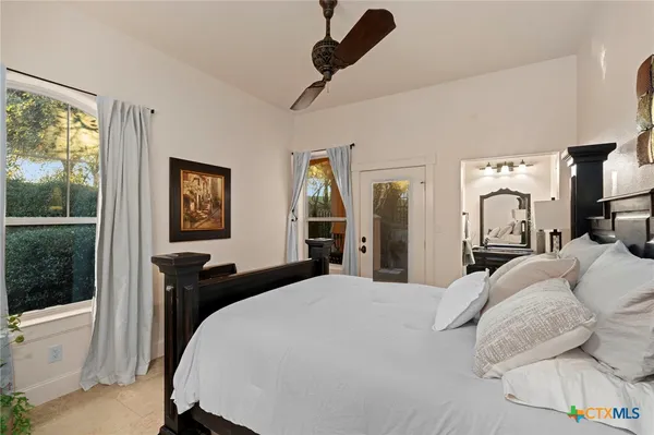 a bedroom with a bed and a large mirror