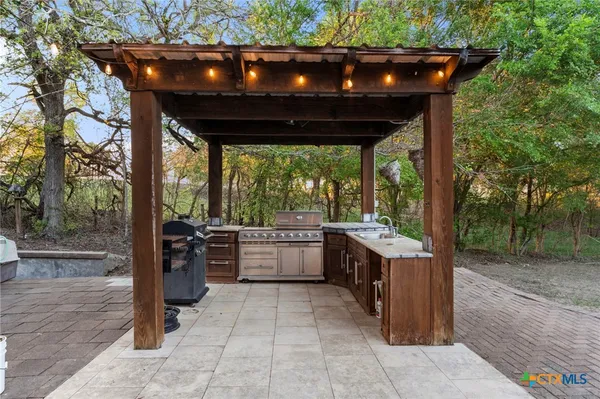 a large kitchen with stainless steel appliances granite countertop a stove and a refrigerator