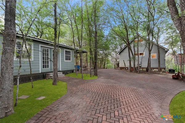a view of a house with a backyard