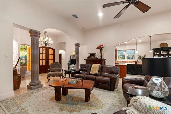 a living room with furniture a rug and white walls