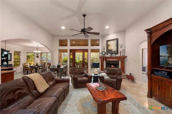 a living room with furniture a fireplace and a flat screen tv