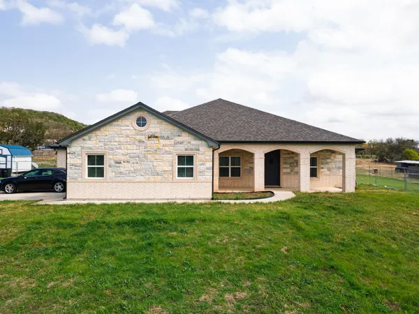 a front view of house with yard and green space