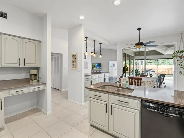 a kitchen with stainless steel appliances granite countertop a sink and cabinets