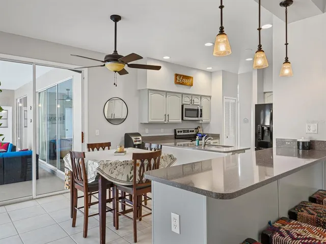 a kitchen with a dining table and chairs