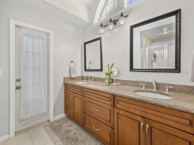 a bathroom with a granite countertop sink a mirror and a