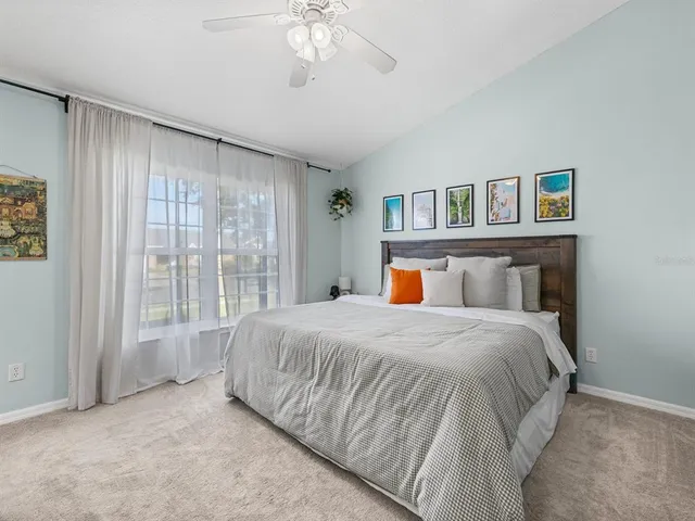 a bedroom with a large bed and a book shelf