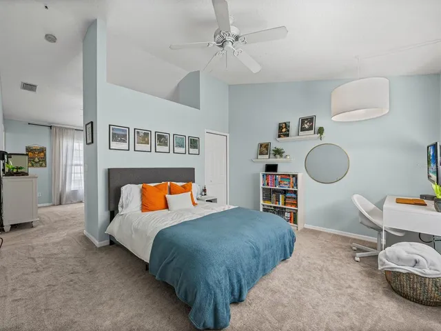 a bedroom with a bed a lamp and a chandelier