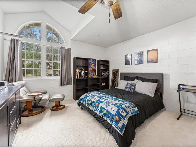 a bedroom with a bed furniture and a large window