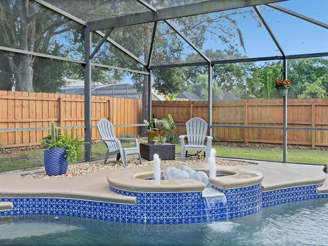 a dining room with glass top table and chairs